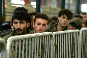 ASYLUM SEEKERS QUEUE FOR MEALS INSIDE THE SANGATTE RED CROSS REFUGEES CAMP IN NORTHERN FRANCE.