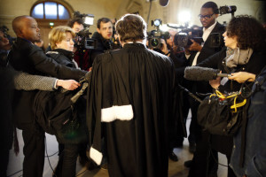 A lawyer speaks to the media as he arrives for the start of the trial of former Rwandan army captain Pascal Simbikangwa at a Paris court